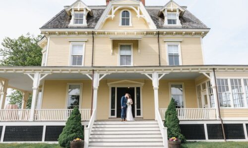 Outdoor tented reception at Eisenhower House in Rhode Island with long tables and greenery, day-of coordination by Weddings by TMW Productions.
